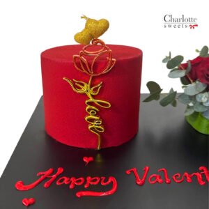 a red and gold cake with a rose and a flower